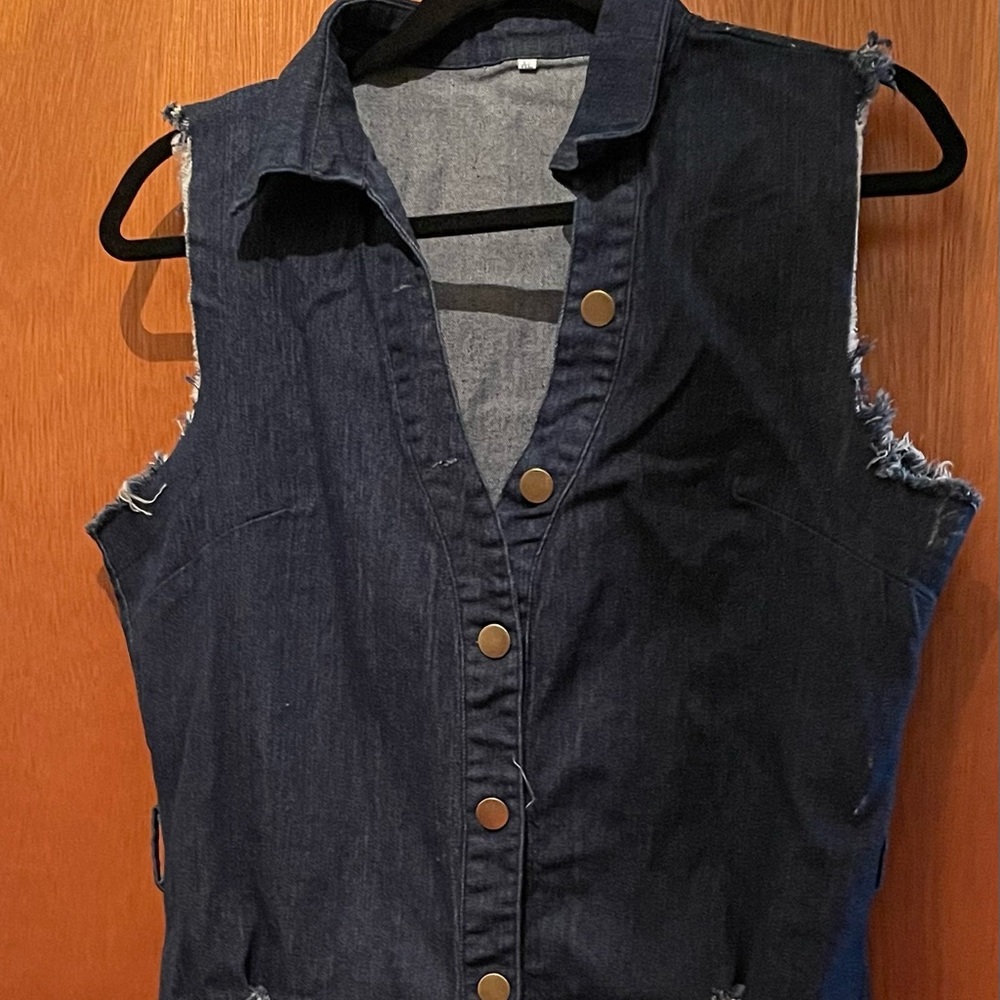 Sleeveless blue jean dress with buttons down front.